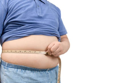 obese fat boy measuring tape of stomach isolated on white  background, healthy and lose weight conceptの写真素材