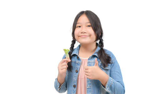 Cute asian girl hold Thai salad rolls and thumb up isolated on white background, healthy food and diet conceptの写真素材