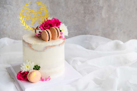 Cute Naked cakes Decorated with Macaron and rose flower on white cloth background. modern cake and...