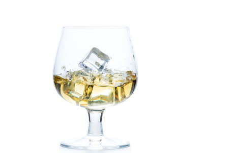 whiskey or brandy with ice in Snifter or Balloon glass isolated on white background, beverage conceptの写真素材