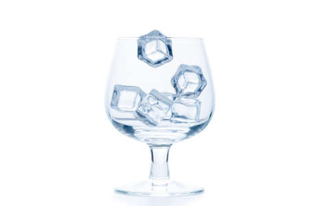 drop ice cubes in to empty Snifter or Balloon glass isolated on white background, beverage conceptの写真素材