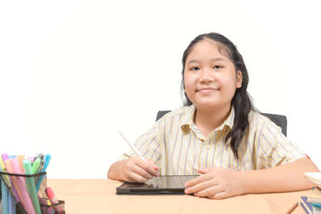 Happy girl student writes on digital tablet to study at home isolated on white background. Education...
