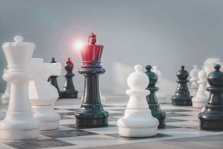 black queen chess surrounded by a number of white chess pieces , business strategy concept