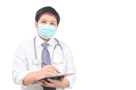 Asian young Doctor writing note information of patient in paperwork checklist on clipboard isolated on white background, health and working conceptの写真素材