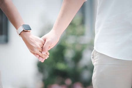 The groom holds the bride's hand in garden. wedding conceptの写真素材