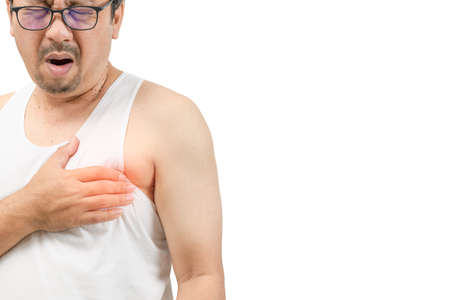 A middle aged man in white veat suffering from chest pain with painful expression and touching his...