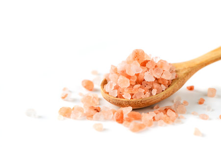 Himalayan Rock pink Salt on wood spoon isolated on white backgroundの写真素材