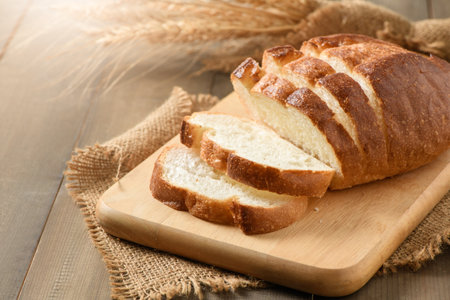 Sliced of fresh homemade french breads on wood background, bakery concept