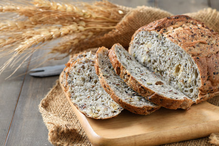 Sliced Multi grain sourdough on wood plate with Barley rice, home made bakery concept.