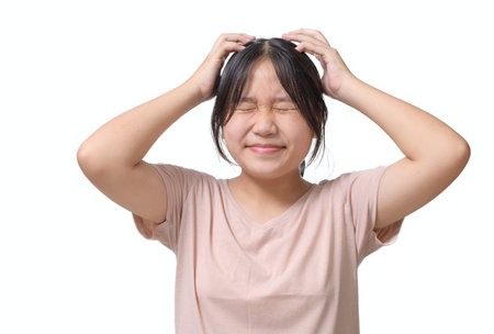 Girl itchy his hair or frustrated and angry kid isolated white background, problem Health conceptの写真素材