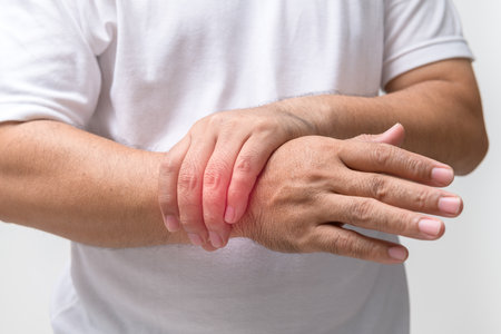 Hand man felt his wrist hurt and massaging sore zone isolated on white background due to excessive...