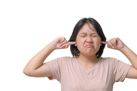 Annoyed stressed girl cover ears feel hurt ear ache pain otitis suffer from loud noise sound headache, irritated stubborn girl deaf hear not listen to noisy music isolated on white backgroundの写真素材