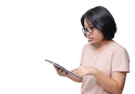 smart Asian Girl Browsing Social Networks On Digital Tablet isolated on white Background, Enjoying Modern Technologies, Copy Spaceの写真素材
