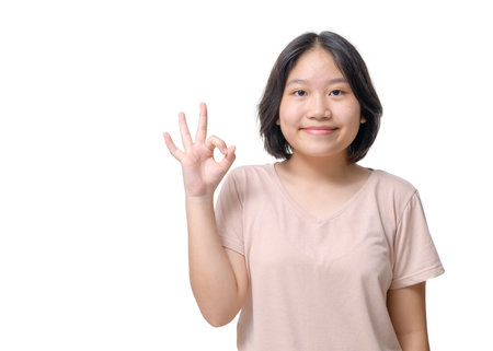 Close-up portrait of her she nice attractive lovely cheerful asian girl showing ok-sign ad solution good choice isolated on white backgroundの写真素材