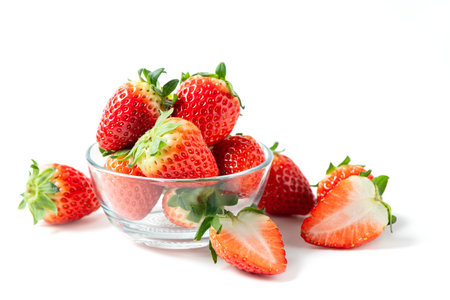 Strawberry on glass isolated on white background. Strawberries with leaf isolate. Whole and half of strawberry on white. Strawberries isolate. Side view strawberriesの写真素材