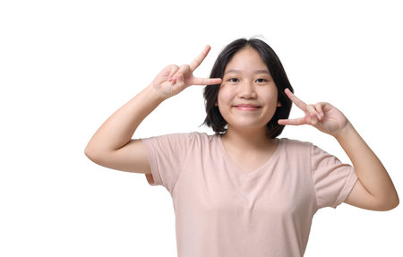 Cute Asian short hair girl in brown t-shirt  on white background isolated. Emotion conceptの写真素材