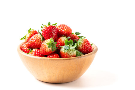 Strawberry on wood cup isolated on white background. Strawberries with leaf isolate. Whole and half of strawberry on white. Strawberries isolate. Side view strawberriesの写真素材