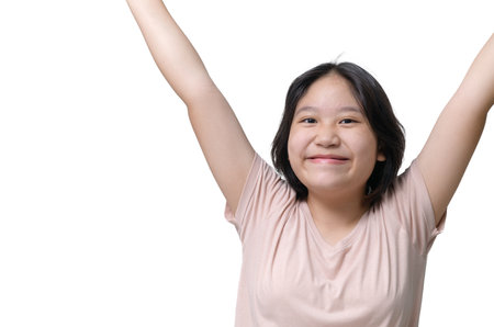 Cute girl wearing a t-shirt raises her hands and smiles happily. emotion conceptの写真素材