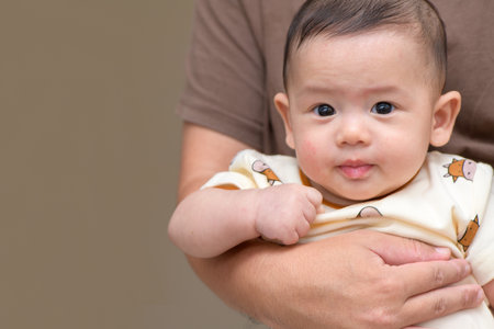 cute cheerful baby smile in mother hand. emotion infant concept