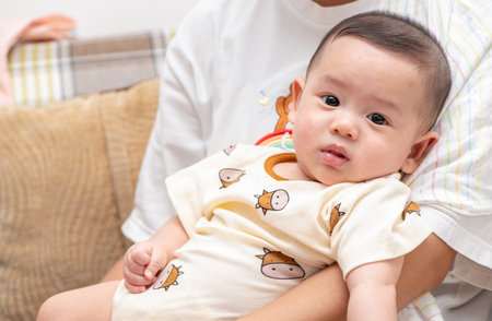 cute cheerful baby in mother hand. emotion infant conceptの写真素材