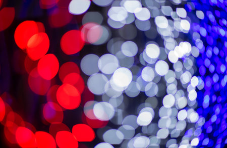 Abstract colorful bokeh orbs on dark background, vibrant defocused light dots pattern, festive overlay texture for photo editing, blurred bright circular shapes for creative graphic design backdropの写真素材