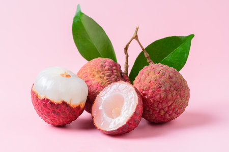 Juicy Lychee with cut in half and leaves isolated on pink background.Thai fruits conceptの写真素材