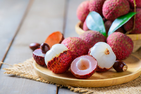 Juicy Fresh Lychee in Bamboo Basket on Rustic Wooden Table â Tropical Exotic Fruit or summer themed content.の写真素材