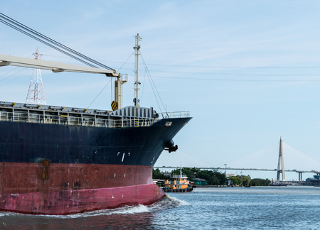 Cargo ships are leaving from the river to the sea.の写真素材