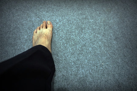 Look on two feet, The shadow of the old cement wall surface with cracks, texture, backgrounds for designの写真素材