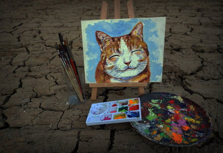 Hand drawn Modern , Art painting Oil color Cute Cat , Palette and paintbrush on Cracks in the soil ,from gallery in Thailandの写真素材