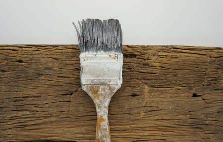 Paint brushes placed on an old wooden board.の写真素材