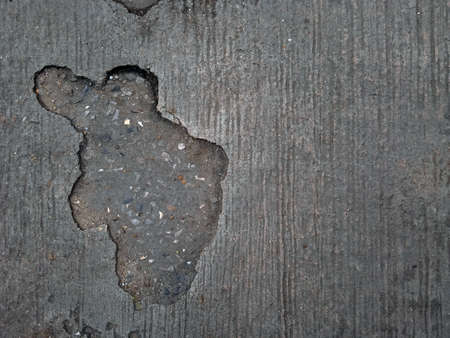 cracked cement covered with gray cement surface as background for designの写真素材