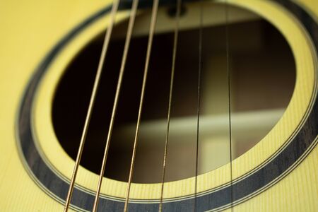 Close up of acoustic guitar with metal strings. Music concept