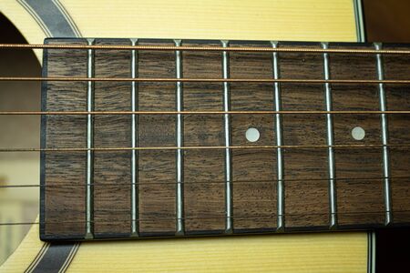 Close up of acoustic guitar with metal strings. Music concept