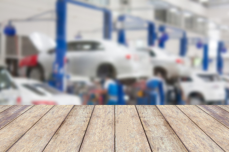 Wood table top with blur garage background, for product display or montage your productsの写真素材