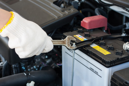Hand with wrench repairing and checking car engineの写真素材