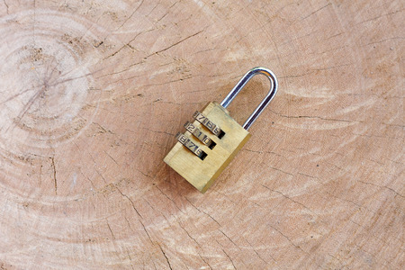 Close up pad lock on wooden background