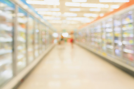 supermarket aisle with refrigerators blurred backgroundの写真素材
