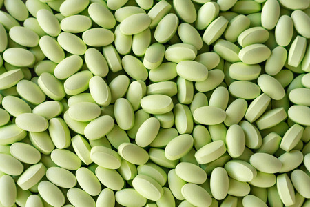 Many green pills medicines backgroundの写真素材