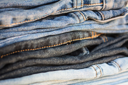fashionable clothes, pile of jeansの写真素材