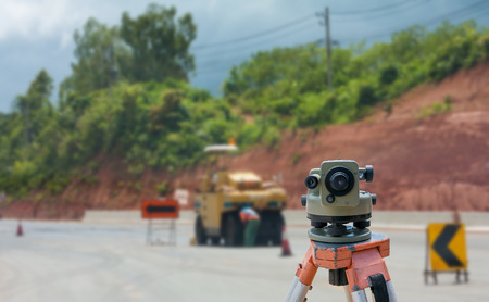 road construction site, theodolite instrument for road construction surveyor equipment with road construction site works blur backgroundの写真素材