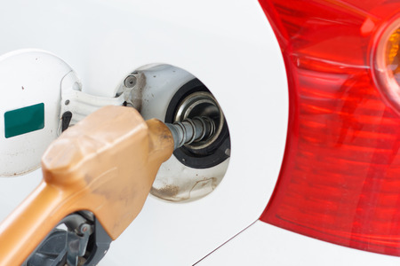 To fill the machine with fuel. Car fill with gasoline at a gas station. Gas station pump.Car gas...