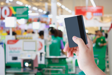 Paying credit card for purchases at the supermarketの写真素材