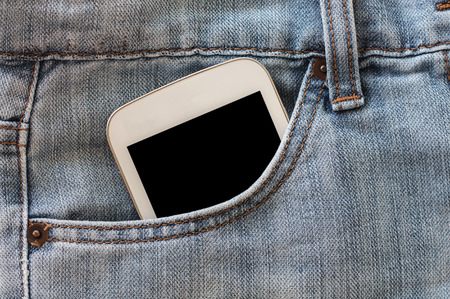 mobile phone in jeans pocket with black screenの写真素材