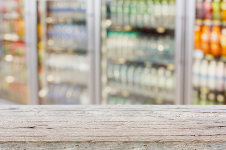 Empty table with blur supermarket refrigeratorr backgroundの写真素材