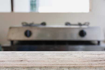 wood table with blurred kitchen background, product displayの写真素材