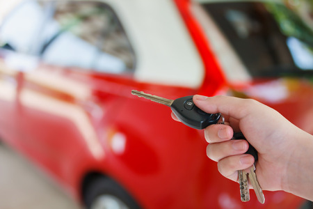 women hand presses on the remote control car alarm systemsの写真素材