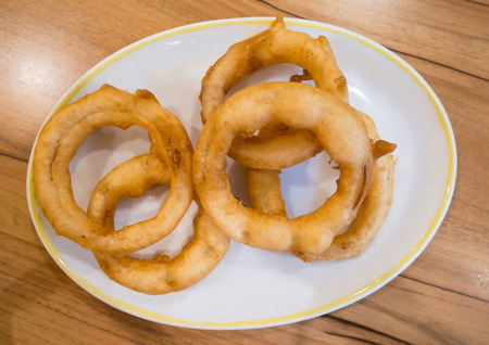 fried onion rings on white plateの写真素材