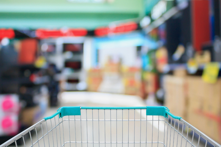 shopping cart with eletronic department store blurred backgroundの写真素材