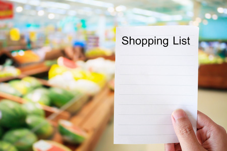 hand hold shopping list in Supermarketの写真素材